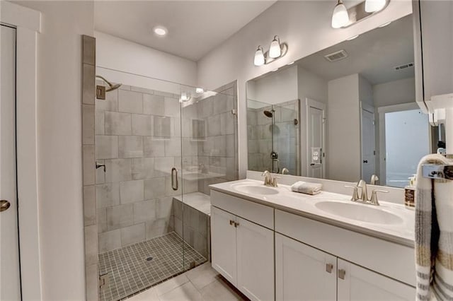 bathroom featuring a sink, visible vents, and a shower stall