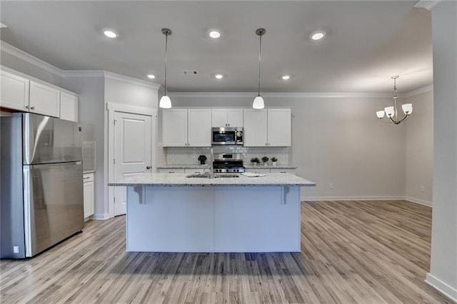 kitchen featuring appliances with stainless steel finishes, white cabinets, crown molding, and tasteful backsplash