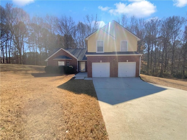 traditional-style home featuring concrete driveway, brick siding, a garage, and a front yard