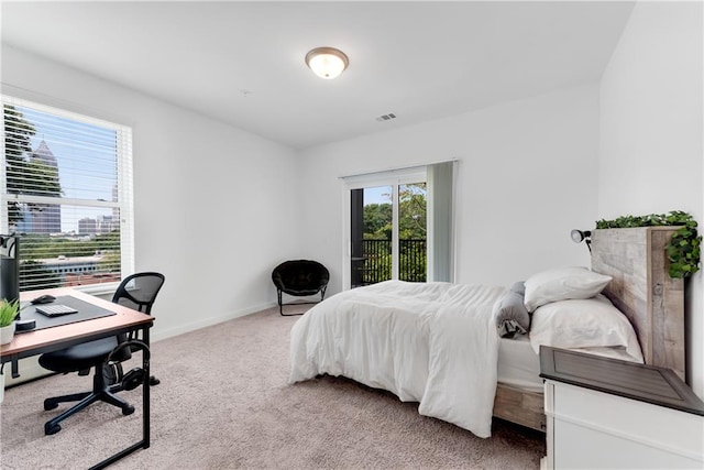 carpeted bedroom featuring access to outside