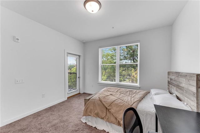 bedroom with carpet and access to outside