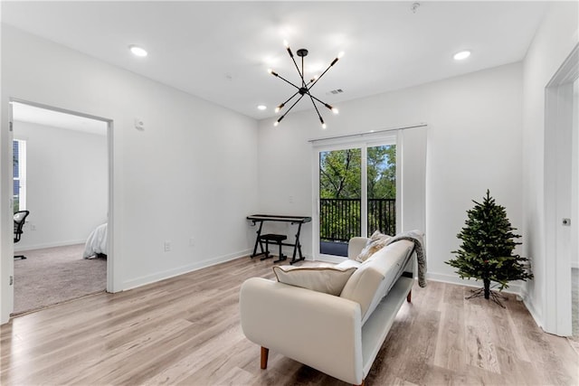 sitting room featuring light hardwood / wood-style flooring and a notable chandelier