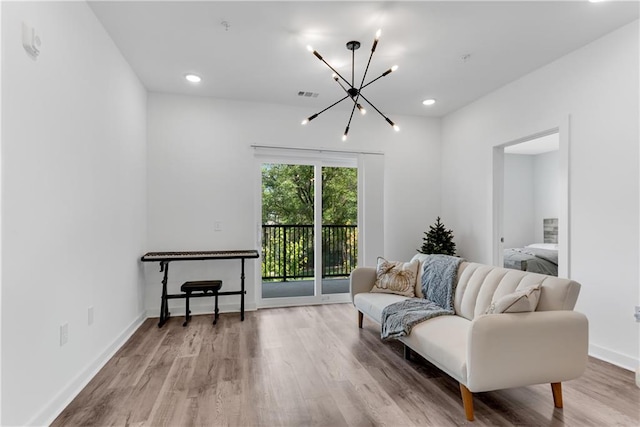 sitting room with a chandelier and hardwood / wood-style flooring