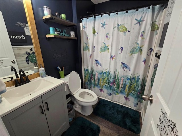 bathroom featuring vanity, hardwood / wood-style flooring, and toilet