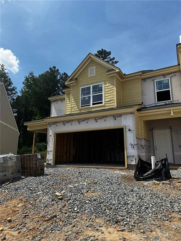 1163 Park Center Cir, Austell, GA 30168 - view of front of home with an attached garage and gravel driveway