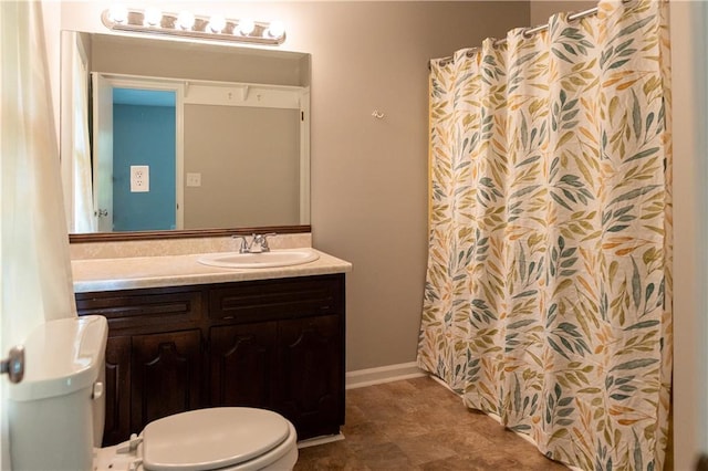 bathroom featuring toilet, vanity, and a shower with shower curtain