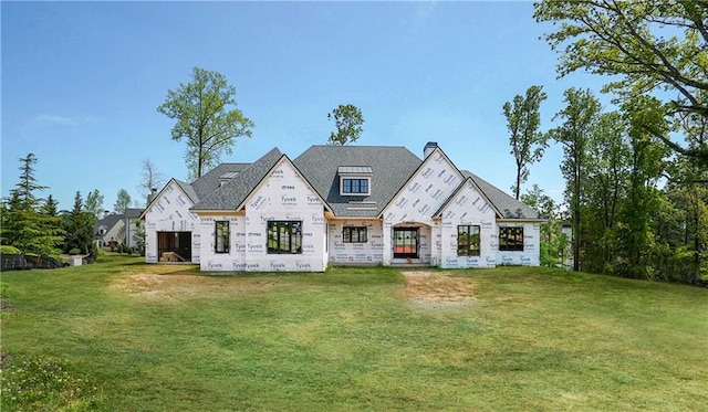 back of house featuring a lawn