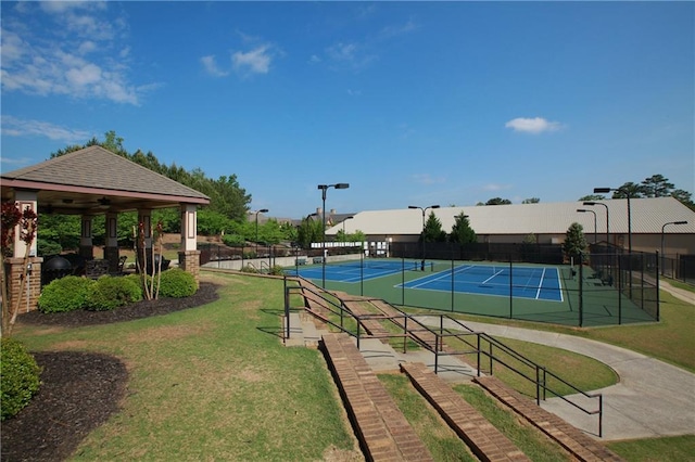 view of home's community with a yard and tennis court