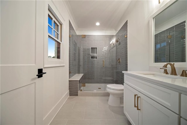 bathroom featuring tile floors, a shower with door, vanity with extensive cabinet space, and toilet