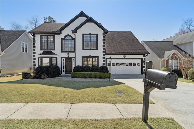 view of front of house featuring stucco siding, driveway, an attached garage, and a front yard