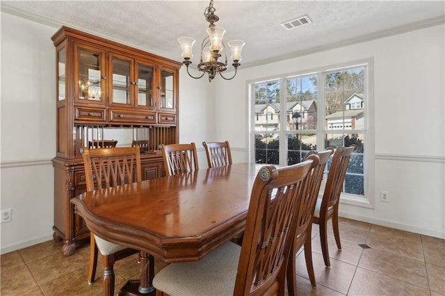 dining room with visible vents, a notable chandelier, a textured ceiling, light tile patterned flooring, and baseboards