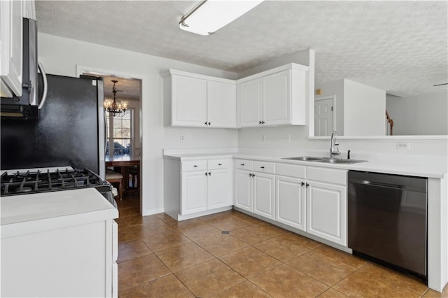 kitchen with freestanding refrigerator, a sink, light countertops, white cabinets, and dishwasher