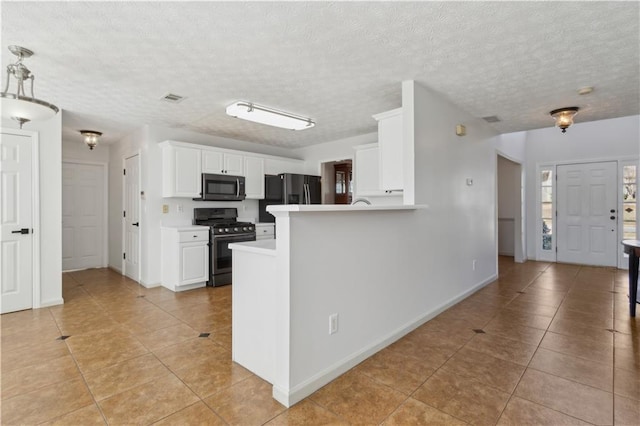 kitchen with visible vents, light countertops, light tile patterned floors, white cabinets, and stainless steel appliances