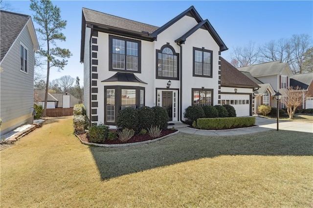 view of front facade featuring stucco siding, driveway, an attached garage, and a front lawn