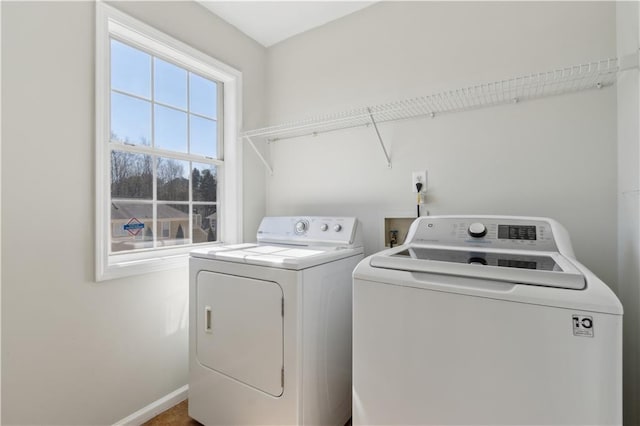 laundry room featuring washer and dryer, laundry area, and baseboards