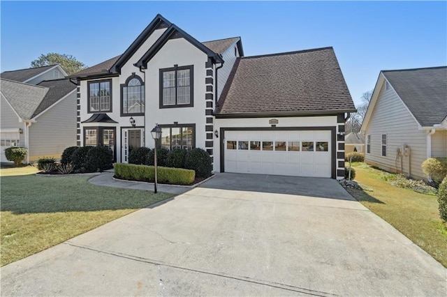 view of front of home featuring stucco siding, an attached garage, concrete driveway, and a front lawn