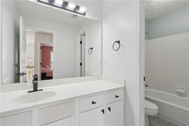 bathroom with vanity,  shower combination, a textured ceiling, toilet, and connected bathroom