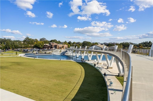 view of pool featuring a lawn