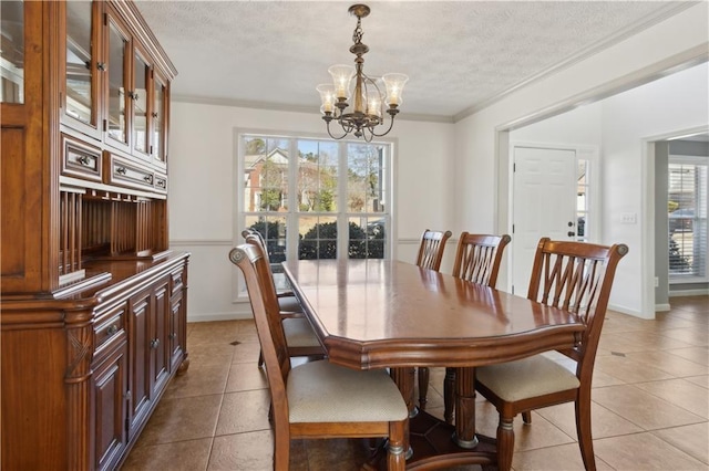 dining room with crown molding, a notable chandelier, light tile patterned flooring, and a textured ceiling