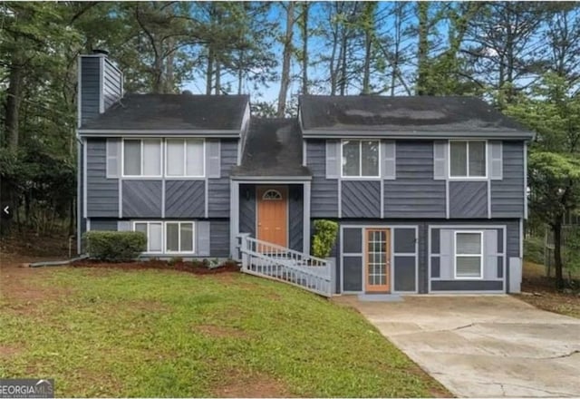 2106 Singer Way, Lithonia, GA 30058 - split foyer home featuring a chimney, a front lawn, and driveway