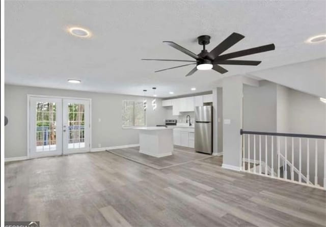 2106 Singer Way, Lithonia, GA 30058 - unfurnished living room with a ceiling fan, recessed lighting, light wood finished floors, and french doors