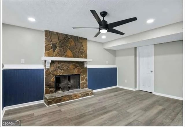 2106 Singer Way, Lithonia, GA 30058 - unfurnished living room with wood finished floors, a ceiling fan, a stone fireplace, and recessed lighting
