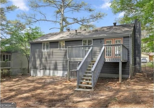 2106 Singer Way, Lithonia, GA 30058 - back of house with a chimney, stairs, and a deck