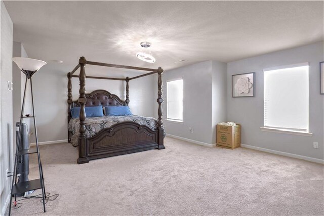 bedroom featuring light colored carpet and multiple windows