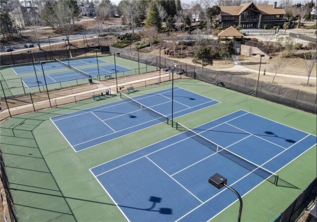 view of tennis court featuring basketball hoop