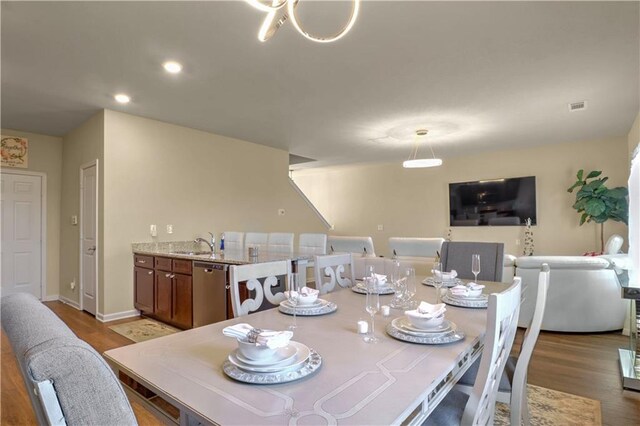 dining space featuring hardwood / wood-style floors and sink