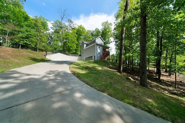 15 Swallow Dr SE, White, GA 30184 - view of property exterior featuring a yard, stairs, and concrete driveway