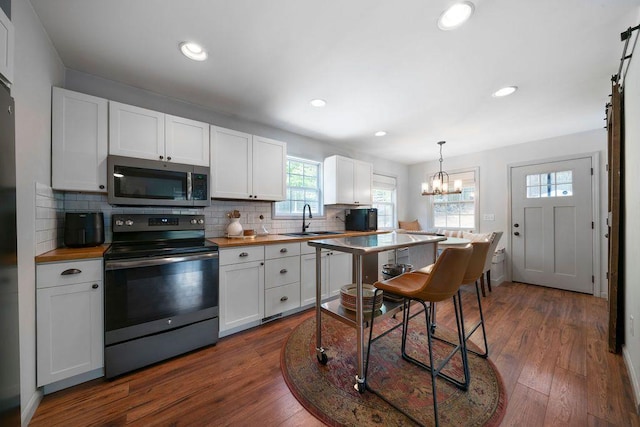 15 Swallow Dr SE, White, GA 30184 - kitchen featuring appliances with stainless steel finishes, a sink, wooden counters, white cabinets, and recessed lighting