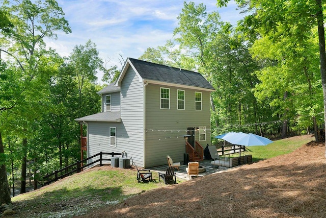15 Swallow Dr SE, White, GA 30184 - rear view of property featuring central AC unit, stairs, and roof with shingles