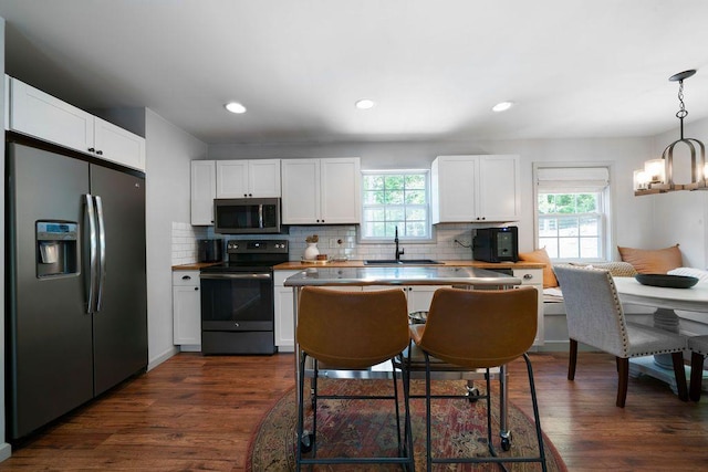 15 Swallow Dr SE, White, GA 30184 - kitchen with stainless steel appliances, a sink, plenty of natural light, white cabinetry, and recessed lighting