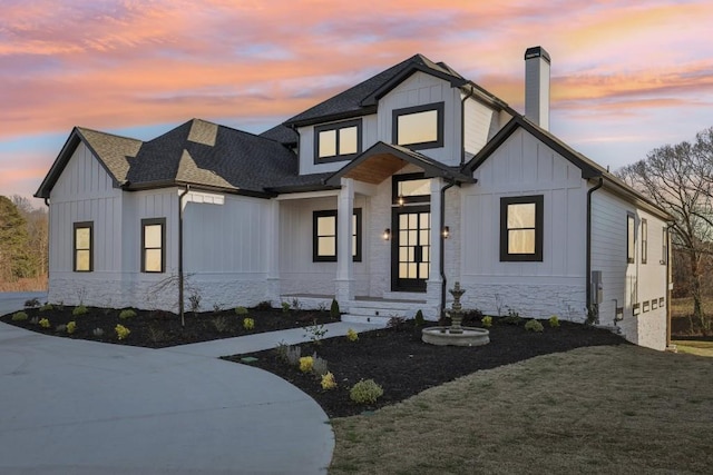 modern farmhouse style home with a yard