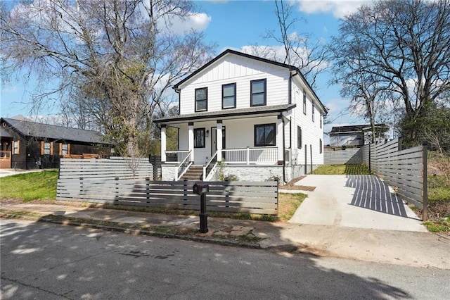 912 Ira St SW, Atlanta, GA 30310 - american foursquare style home with covered porch, a fenced front yard, board and batten siding, and driveway