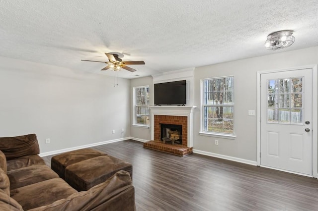 living room with dark wood-type flooring, a fireplace, baseboards, and ceiling fan