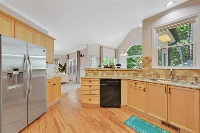 kitchen with black dishwasher, a healthy amount of sunlight, light brown cabinetry, and stainless steel refrigerator with ice dispenser