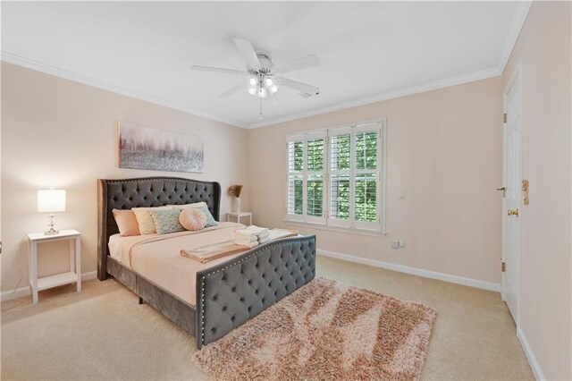 carpeted bedroom with ceiling fan and crown molding