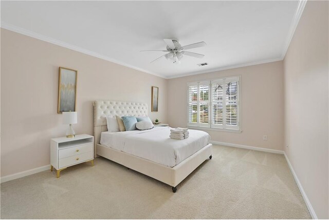 carpeted bedroom with ceiling fan and ornamental molding