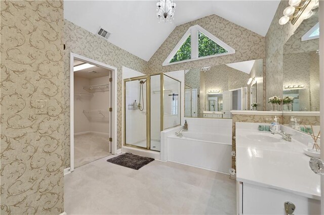 bathroom with vanity, vaulted ceiling, and independent shower and bath