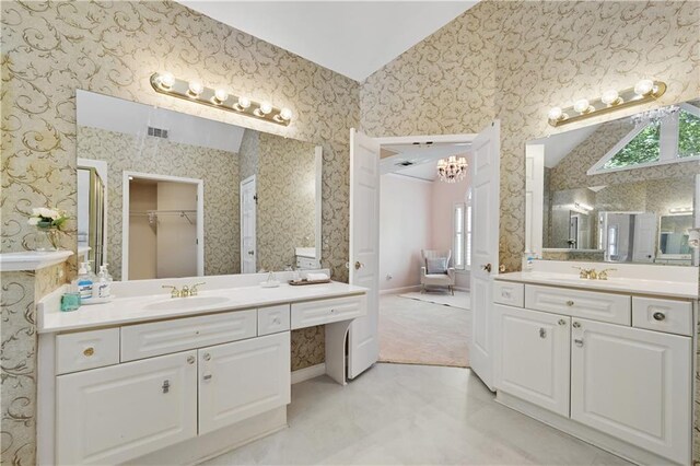 bathroom with vanity and vaulted ceiling