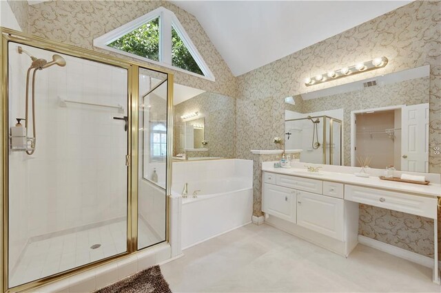 bathroom featuring lofted ceiling, shower with separate bathtub, and vanity