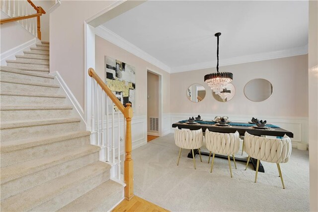 dining area featuring ornamental molding and a chandelier