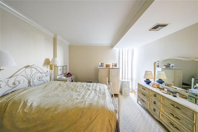 bedroom featuring light carpet and ornamental molding