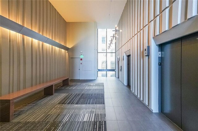 interior space featuring a high ceiling and elevator