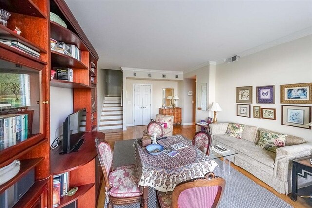 living room featuring crown molding and wood-type flooring