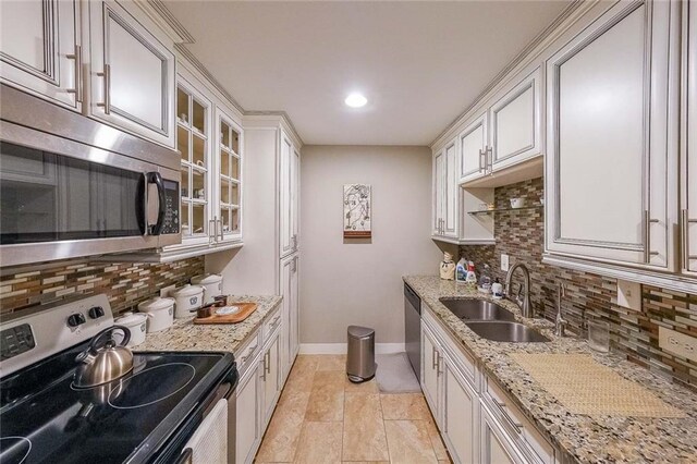 kitchen with sink, appliances with stainless steel finishes, and tasteful backsplash