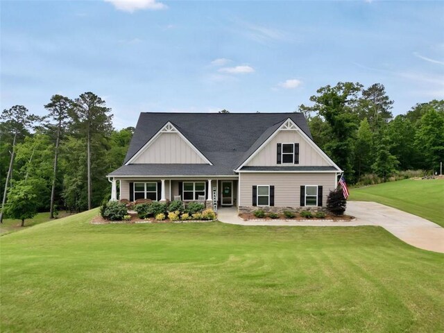 210 Riverpoint Way, Jackson, GA 30233 - view of front of house with board and batten siding, a front yard, and a porch