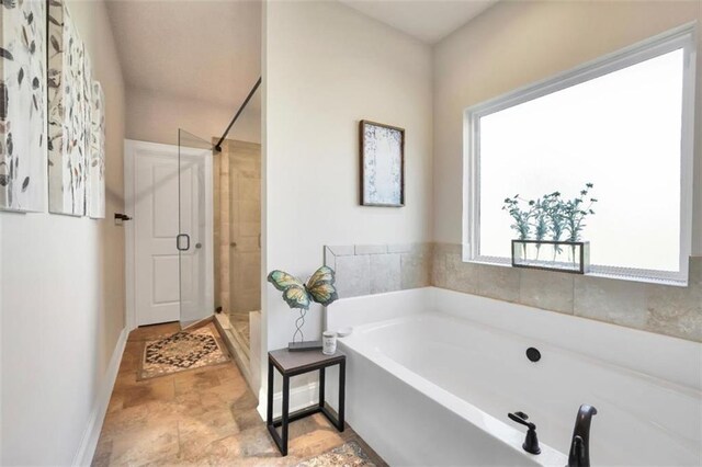 210 Riverpoint Way, Jackson, GA 30233 - full bathroom featuring a stall shower, a bath, and baseboards